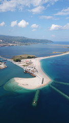 Obraz premium Aerial drone bird's eye view of famous and exotic sand tongue beach with clear emerald waters near castle of Santa Mavra in entrance of Lefkada island, Ionian, Greece