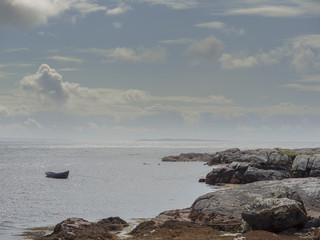 Empty fishing boat in the ocean, West coast of Ireland,  county Galway, Atlantic ocean.