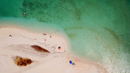 Aerial drone photo of tropical caribbean bay with white sand beach and beautiful turquoise and sapphire clear sea