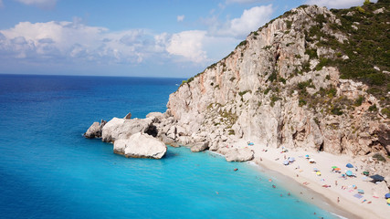 Fototapeta premium Aerial top view photo of sun beds in popular tropical paradise deep turquoise sandy beach of Kathisma, Lefkada island, Ionian, Greece