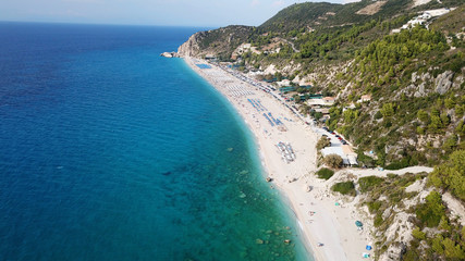 Aerial top view photo of sun beds in popular tropical paradise deep turquoise sandy beach of...