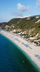 Aerial top view photo of sun beds in popular tropical paradise deep turquoise sandy beach of...