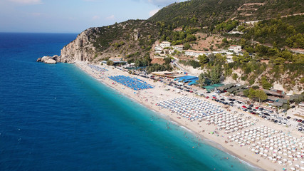 Aerial top view photo of sun beds in popular tropical paradise deep turquoise sandy beach of...