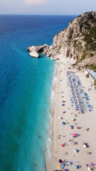 Aerial top view photo of sun beds in popular tropical paradise deep turquoise sandy beach of...