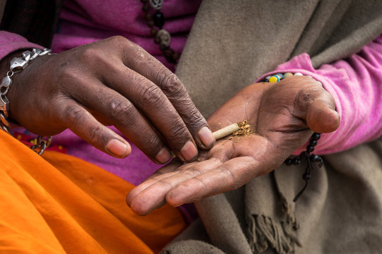 Indus sadhu makes a drug mixture with his hands.