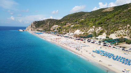 Obraz premium Aerial top view photo of sun beds in popular tropical paradise deep turquoise sandy beach of Kathisma, Lefkada island, Ionian, Greece