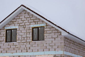 Roof of a country house in the snow in winter