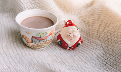 a Cup of hot aromatic drink, warm blanket, elf