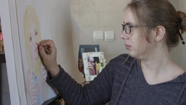 Woman Colouring A Portrait Using a Pensil