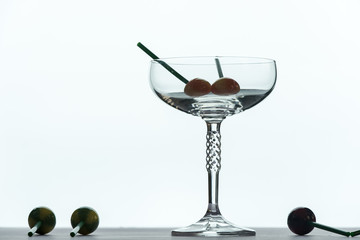 a glass of champagne with a sweet lollipop inside, isolated on a white background