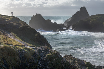 Walker in strong Winds, Kynance Cove, Cornwall