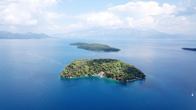 Aerial drone photo of iconic uninhabited island of Madouri in bay of Nydri and Mansion of 19th-century poet Aristotelis Valaoritis, Lefkada, Ionian, Greece