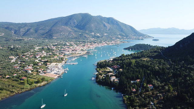 Aerial drone bird's eye view photo of iconic port of Nidri or Nydri a safe harbor for sail boats and famous for trips to Meganisi, Skorpios and other Ionian islands, Leflkada island, Ionian, Greece