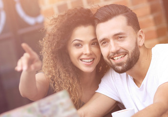 A picture of  tourists looking at map in a cafe