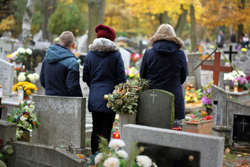 People at the Polish traditional cemetery on the feast of all saints day at 1st November - obrazy, fototapety, plakaty