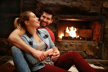 Happy hugging couple enjoying in mountain house
