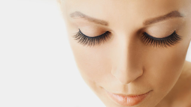 Beautiful girl with long false eyelashes and perfect skin. Eyelash extensions, cosmetology, beauty and skin care