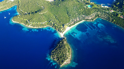 Aerial drone bird's eye view panoramic photo of iconic island of Skorpios that was owned by Aristotle Onasis and port of Nidri at the background, Lefkada island, Ionian, Greece