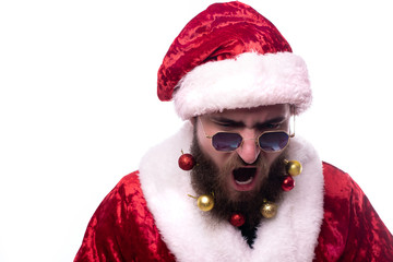 screaming man in Santa Claus costume, black glasses and Christmas toys in the beard Copy-Space