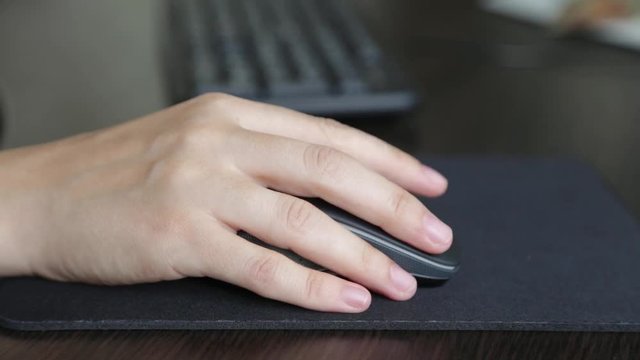 female hand on a computer mouse. use of office equipment for work