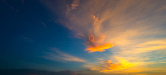 Fototapeta premium Sunlight with dramatic sky. Cumulus sunset clouds with sun setting down on dark background.orange and dark cloud sky.