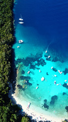 Naklejka na ściany i meble Aerial drone bird's eye view photo of iconic paradise sandy beach of blue lagoon with deep turquoise clear sea and pine trees in complex island of Mourtos in Sivota area, Epirus, Greece