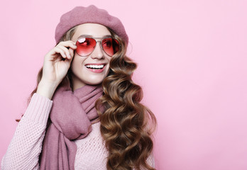 beautiful young female model with long wavy hair wearing pink beret and scarf