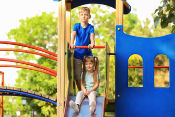 Cute little children outdoors on playground