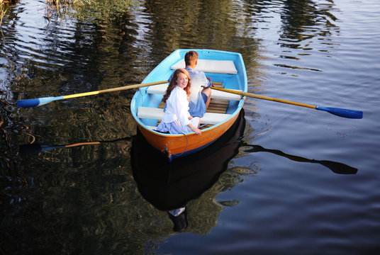 Cute young couple having romantic date in boat