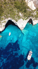 Aerial drone bird's eye view photo of sail boats docked in tropical caribbean paradise bay with...