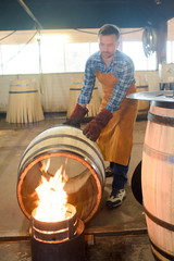 Fototapeta na wymiar cooper heating a barrel