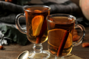 Autumn composition with hot tea and dried apricots on a brown wooden table with a place for inscription.