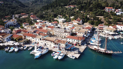 Fototapeta na wymiar Aerial drone bird's eye view photo of iconic small port and fishing village of Lakka with traditional Ionian architecture and sail boats docked, Paxos island, Ionian, Greece