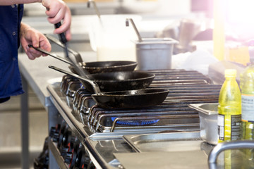 Chef in hotel or restaurant kitchen cooking 
