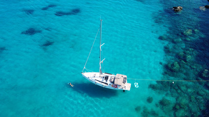 Aerial drone top view photo of luxury sail boats docked in tropical bay with turquoise and emerald...