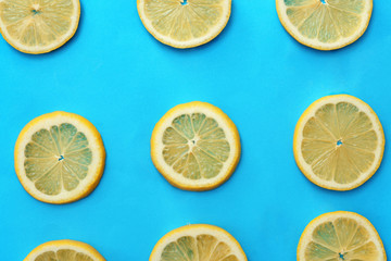 Flat lay composition with lemon slices on color background