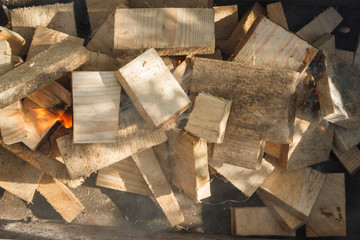 The wood burns in a homemade barbecue