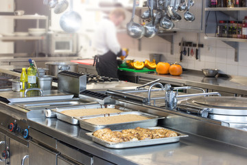 Chef in hotel or restaurant kitchen cooking 
