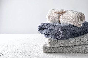 Clean folded towels on white table