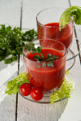 Fresh tomato juice with tomatoes and greens.