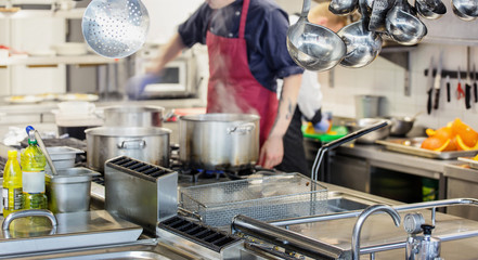 Chef in hotel or restaurant kitchen cooking 
