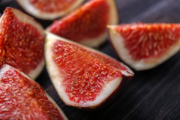 Cut ripe figs on wooden table
