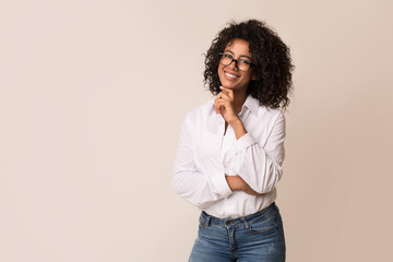Beautiful african-american businesswoman wearing glasses over light background