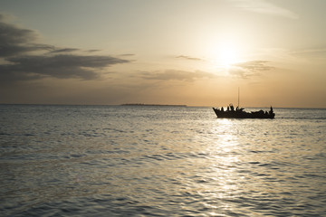 Zanzibar, a typical boat sailing at sunset 