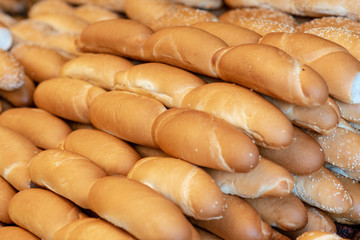 Breads and baked goods close-up. Bakery, baguette, bun, bread roll background.