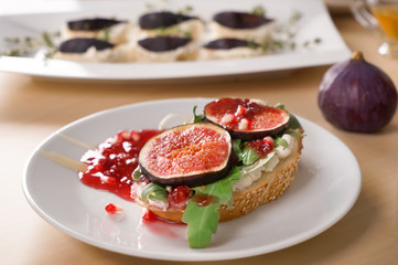 Tasty sandwich with ripe fig and jam on plate