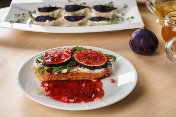 Tasty sandwich with ripe fig and jam on plate