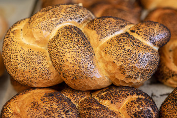 Breads and baked goods close-up. Fresh challah bread for shabbat. Bakery bread bun background.