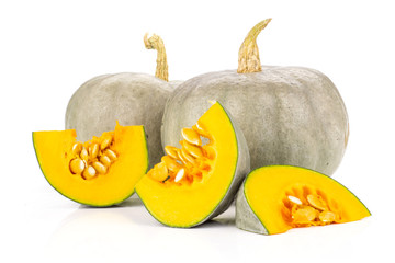 Composition of two whole three slices of fresh blue grey pumpkin nagy dobosi variety isolated on white background