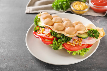 Delicious bubble waffle with vegetables and meat on plate